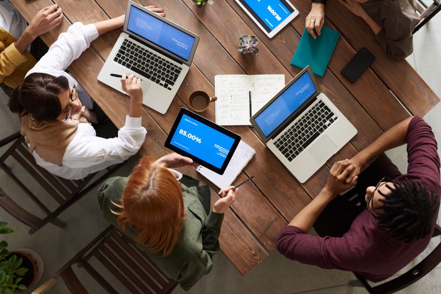 Corporate advisory meeting with business clients around a boardroom table